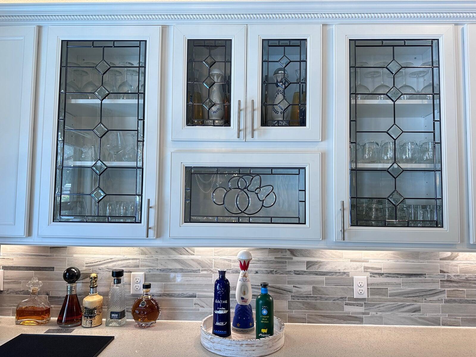Custom leaded cabinet glass featuring a hand-cut crystal bevel cluster and diamond leaded pattern.